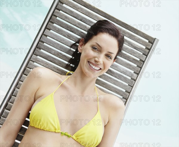 Brunette woman sunbathing. Photo. momentimages