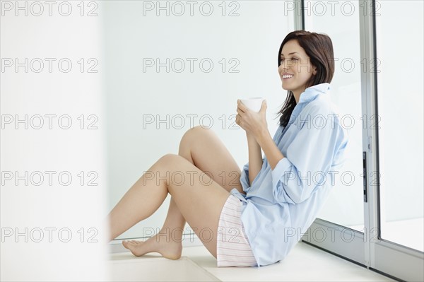 Attractive brunette drinking coffee. Photo. momentimages