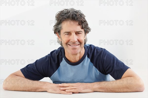 Handsome man sitting at table. Photo : momentimages