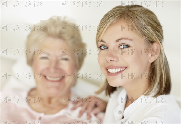 Nurse sitting with a senior woman. Photo. momentimages