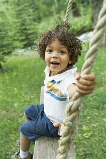 Cute young child sitting on swing. Photo : Shawn O'Connor