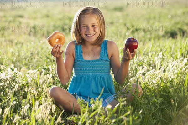 Young girl making food choice. Photo. Mike Kemp