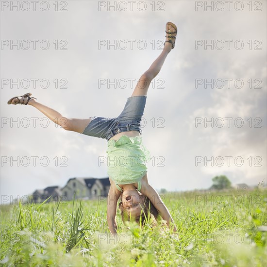Young girl doing cartwheel. Photo. Mike Kemp