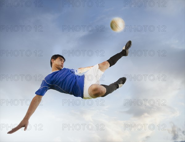 Soccer player kicking ball. Photo. Mike Kemp