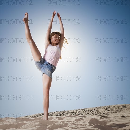 Woman dancing in sand. Photo. Mike Kemp