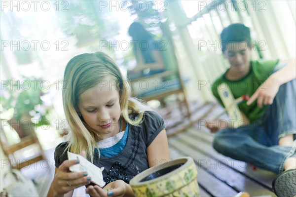 Young girl planting seeds in a planter. Photo : Tim Pannell