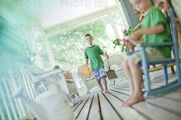 Two young boys on porch. Photo : Tim Pannell