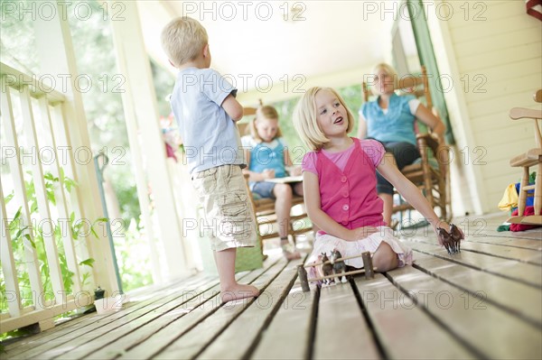 Children playing on porch. Photo. Tim Pannell
