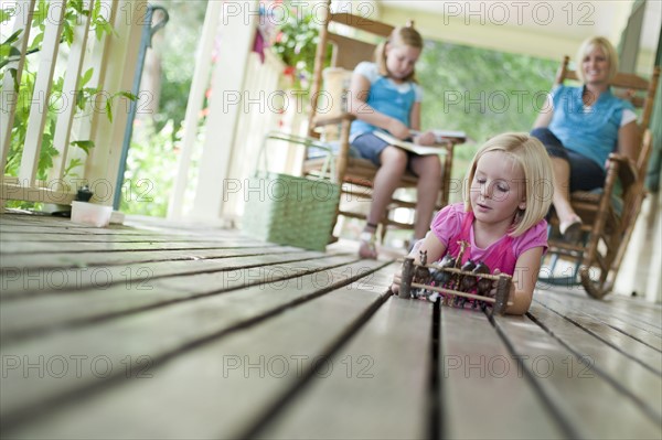 Family relaxing on porch. Photo : Tim Pannell