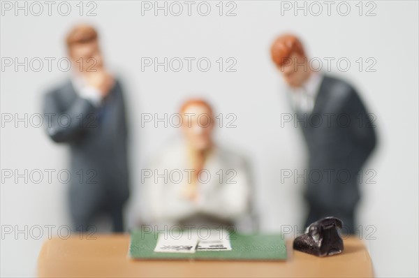 Figurines standing behind person at desk. Photo : Antonio M. Rosario