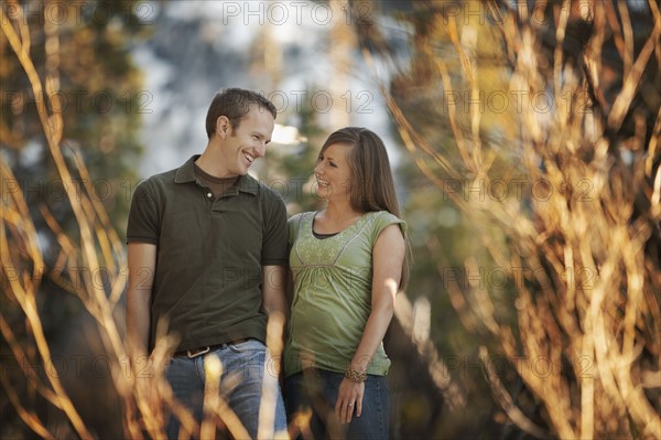 Happy couple walking outdoors together. Photo. FBP