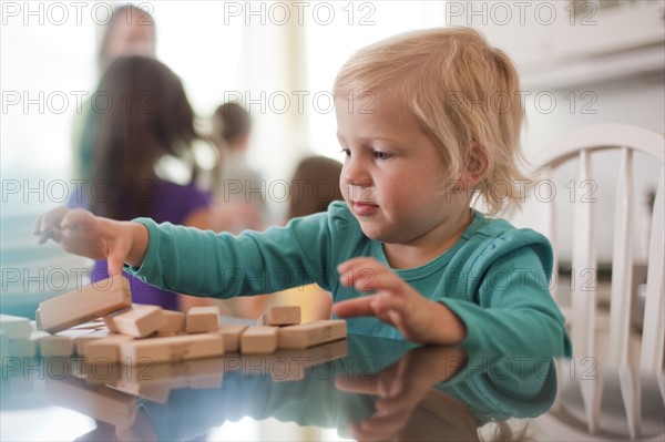 Young girl playing with wooden blocks. Photo : Tim Pannell