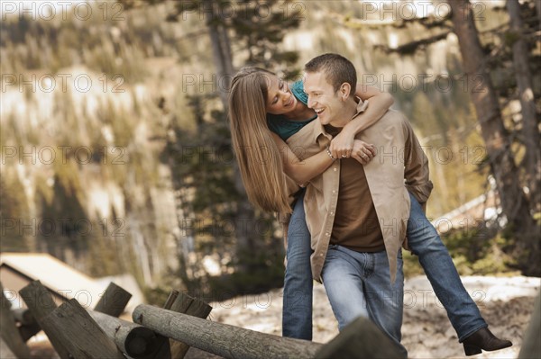 Man giving girlfriend a piggyback ride. Photo. FBP