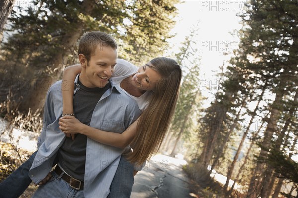 Man giving girlfriend a piggyback ride. Photo. FBP