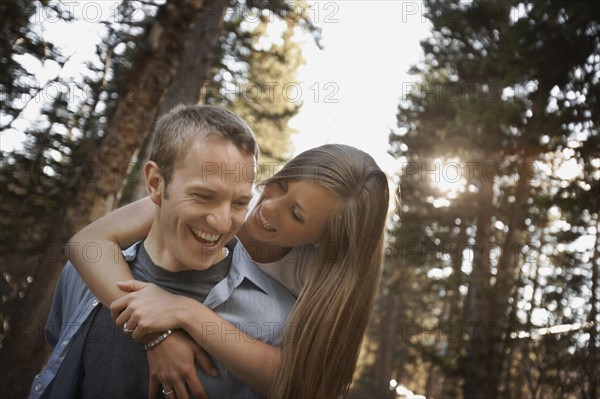 Man giving girlfriend a piggyback ride. Photo. FBP