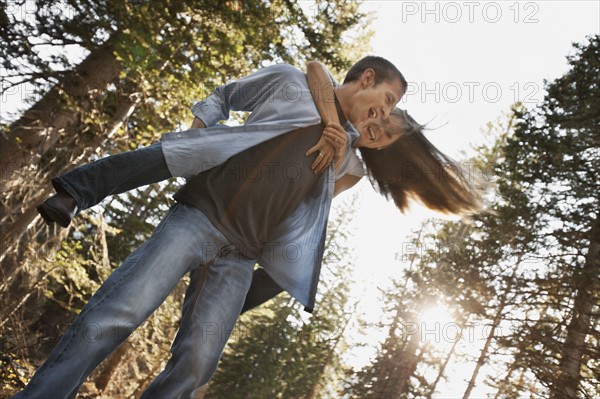 Man giving girlfriend a piggyback ride. Photo. FBP