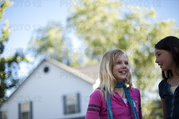 Two young girls talking outside. Photo. Tim Pannell