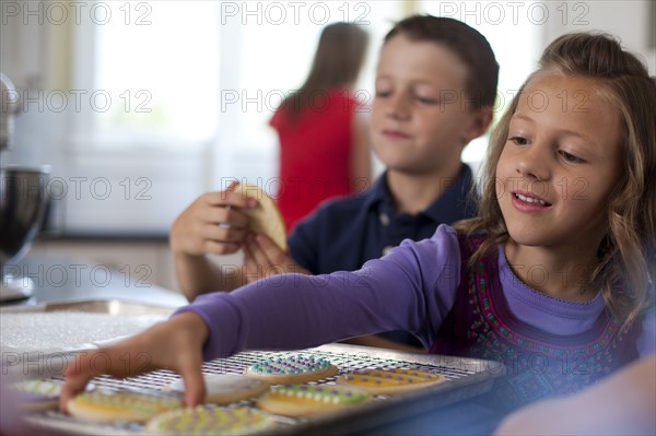 Children baking cookies. Photo. Tim Pannell