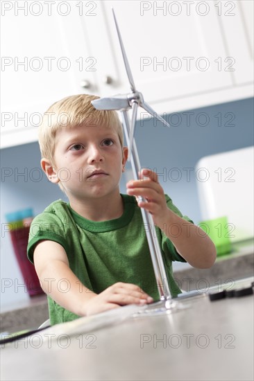 Little boy looking at model windmill. Photo : Tim Pannell