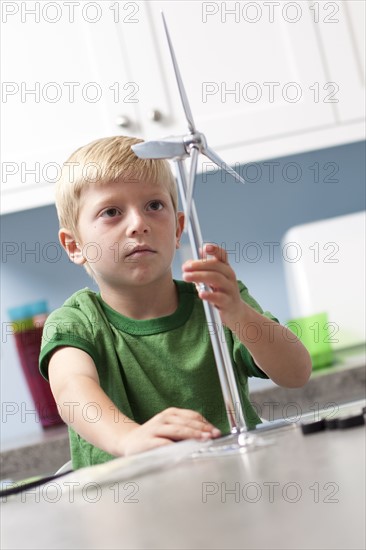 Little boy looking at model windmill. Photo. Tim Pannell