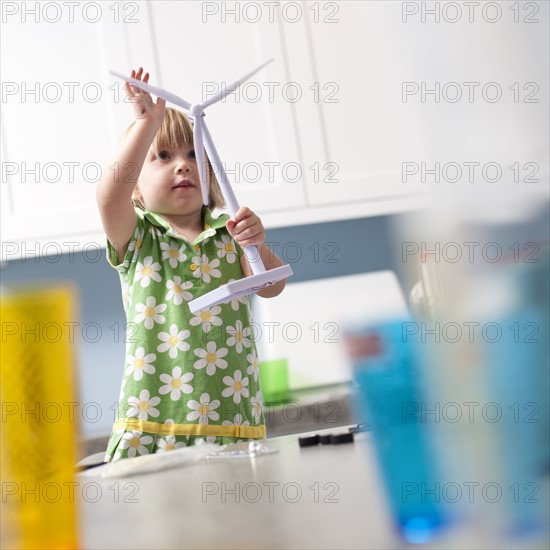 Little girl looking at model windmill. Photo. Tim Pannell