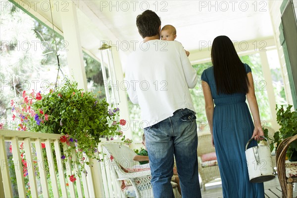 Young family walking on porch. Photo : Tim Pannell