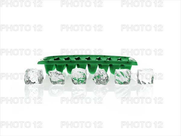 Ice cubes and green ice cube tray. Photo. David Arky