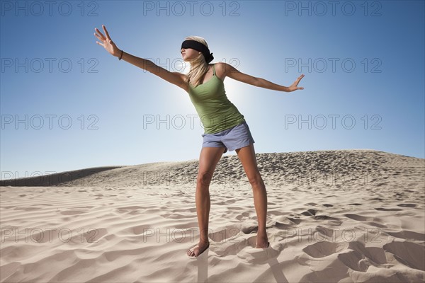 Woman wearing blindfold in the desert. Photo : Mike Kemp