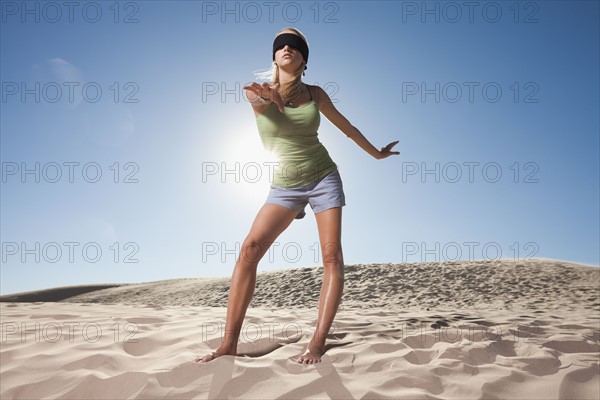 Woman wearing blindfold in the desert. Photo : Mike Kemp