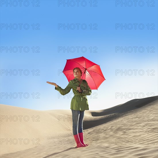 Woman waiting for rain in the desert. Photo. Mike Kemp