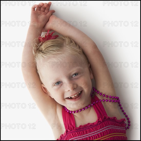 Cute young girl lying down. Photo : Mike Kemp