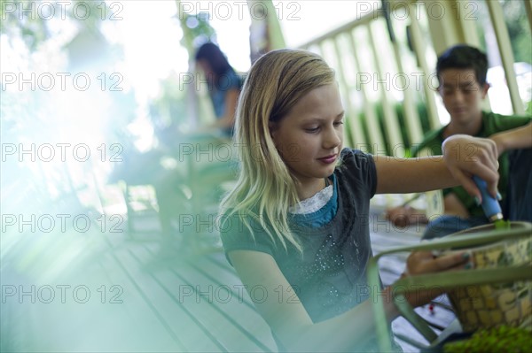 Young girl potting a plant. Photo. Tim Pannell