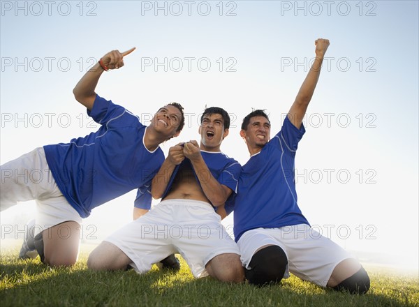 Three happy soccer players. Photo : Mike Kemp