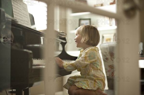 Young girl playing piano. Photo. Tim Pannell