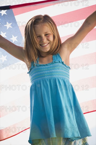 Young girl holding American flag. Photo : Mike Kemp