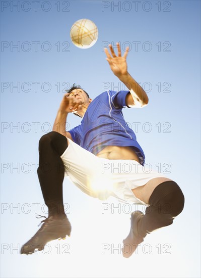 Soccer player heading the ball. Photo. Mike Kemp