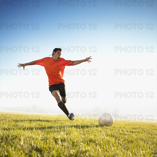 Soccer player kicking the ball. Photo. Mike Kemp