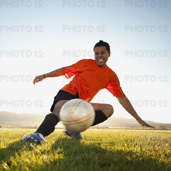 Soccer player kicking the ball. Photo. Mike Kemp