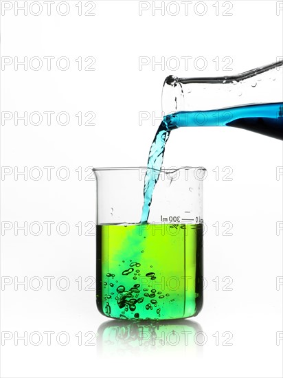 Blue liquid being poured into measuring cup. Photo : David Arky