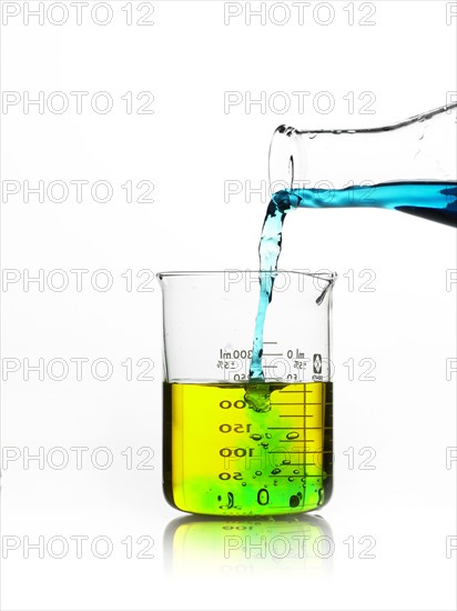 Blue liquid being poured into measuring cup. Photo : David Arky