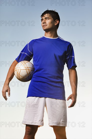Soccer player holding ball. Photo. Mike Kemp