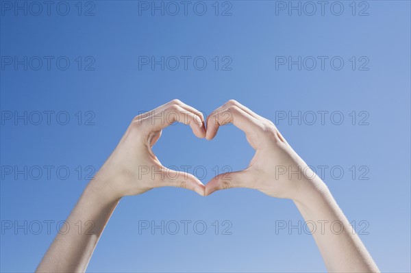 Hands forming a heart shape. Photo : Chris Hackett