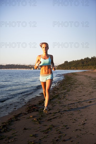 Woman running on the beach. Photo : Take A Pix Media