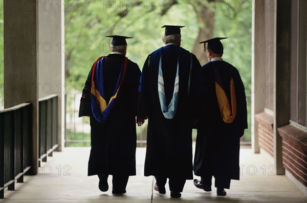 Three adult graduates. Photo. Stewart Cohen
