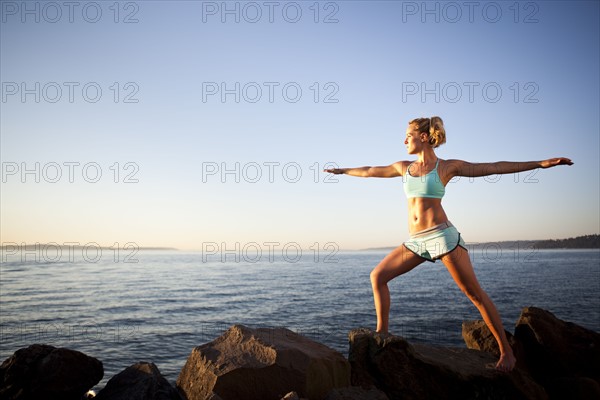 Athletic woman stretching outdoors. Photo : Take A Pix Media