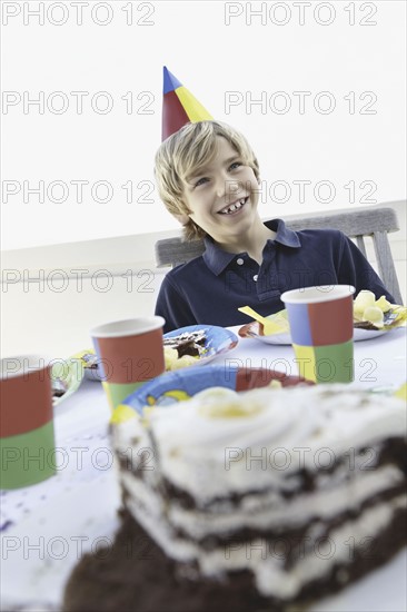 Young boy at a birthday party. Photo. momentimages