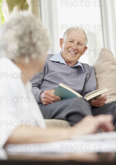 Senior man reading a book. Photo. momentimages