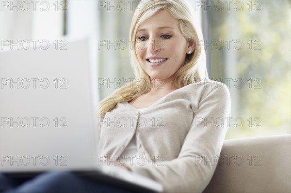 Attractive blond woman browsing the internet. Photo. momentimages