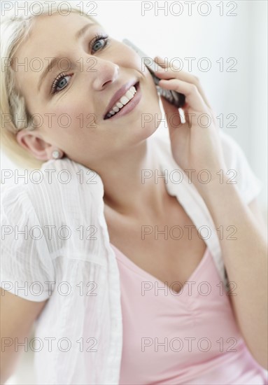 Pretty blond woman talking on phone. Photo : momentimages