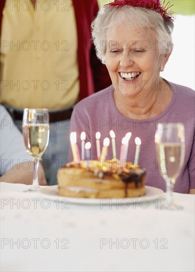 Senior woman at a birthday celebration. Photo. momentimages